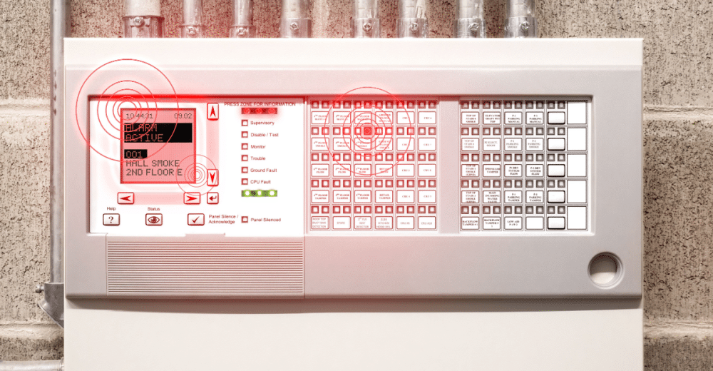 A fire alarm system control center attached to a cement wall. 