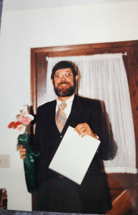 AIE Robert Warmann Holding 1st Contract & a bunch of flowers.